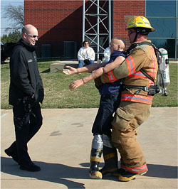 Fire fighter carrying a dummy to the target area.