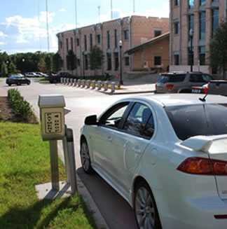 Car pulled up to the utility drop box at the Government Center, paying a bill.